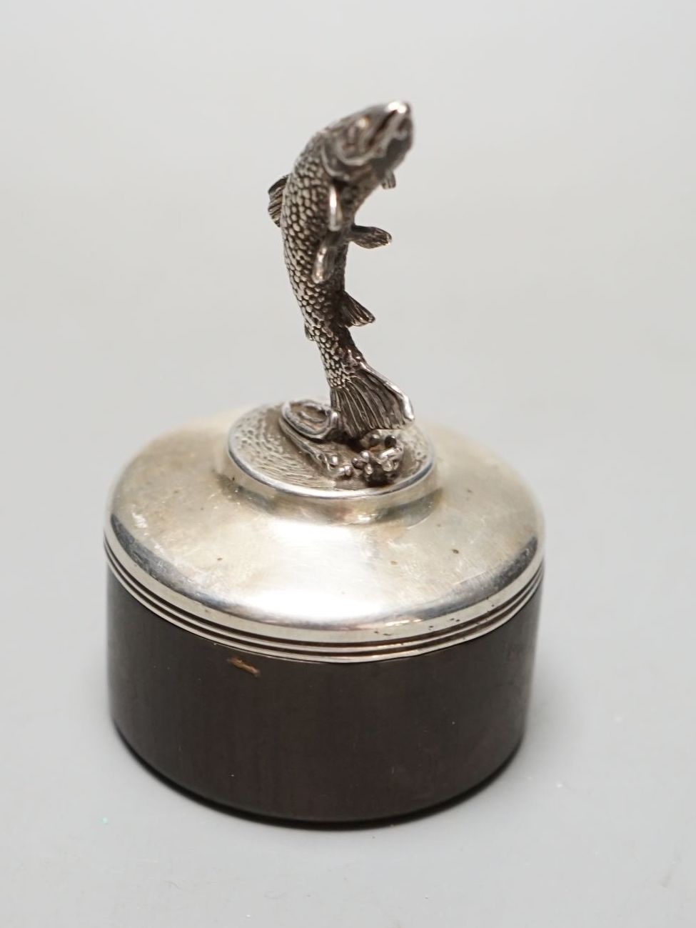 A modern silver mounted wooden box and cover by Brian Leslie Fuller box, with leaping salmon finial, London, 1990, height 85mm.